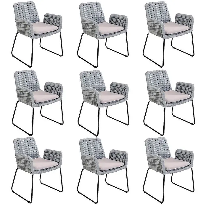 Home Deluxe Gartenstuhl mit Armlehnen BALERO - 9er Set - Pulverbeschichtet, Hellgrau - Set aus hellgrauen, geflochtenen Sesseln mit hellrosafarbenen Kissen und schwarzen Metallrahmen.
