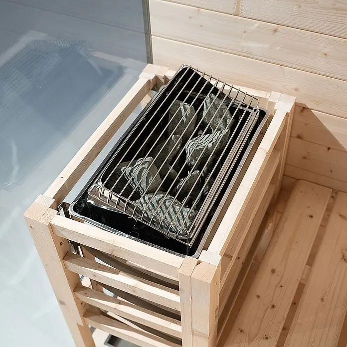 Home Deluxe Elementsauna SHADOW L - Elektroofen, Steuerung Ofen: Integriert, L x B x H: 120 x 150 x 190 cm - Hellholzgerahmter Saunaofen mit grauen Steinen auf Metallschale und Rost.
