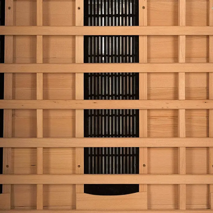 Home Deluxe Infrarotkabine REDSUN DELUXE XXL -  - Helle Holzlamellenverkleidung mit schwarzen Gittern, typisch für eine Sauna zum Heizungsschutz und zur Wärmeverteilung.