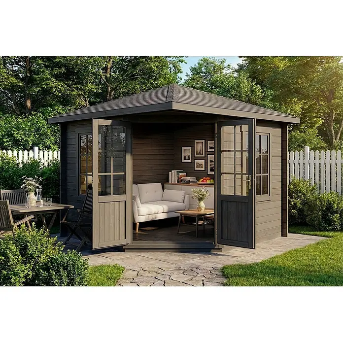 Alpholz Gartenhaus Monica - Außenmaß inkl. Dachüberstand (B x T): 320 x 320 cm, Holz, Grau - Dunkelgraues Holzgartenhaus als gemütliche Lounge mit weißem Sofa, auf Steinweg neben Essgruppe im Freien.
