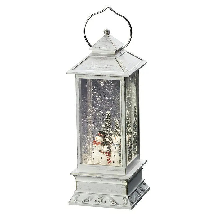 Konstsmide LED-Schneelaterne Schneemänner - Innen, Weiß, 10,5 x 10,5 x 27,5 cm, Batteriebetrieben - Winterliche Dekoration: Eine weiße Laterne mit Schneemännern und Bäumen im Inneren, umgeben von glitzerndem Schnee.