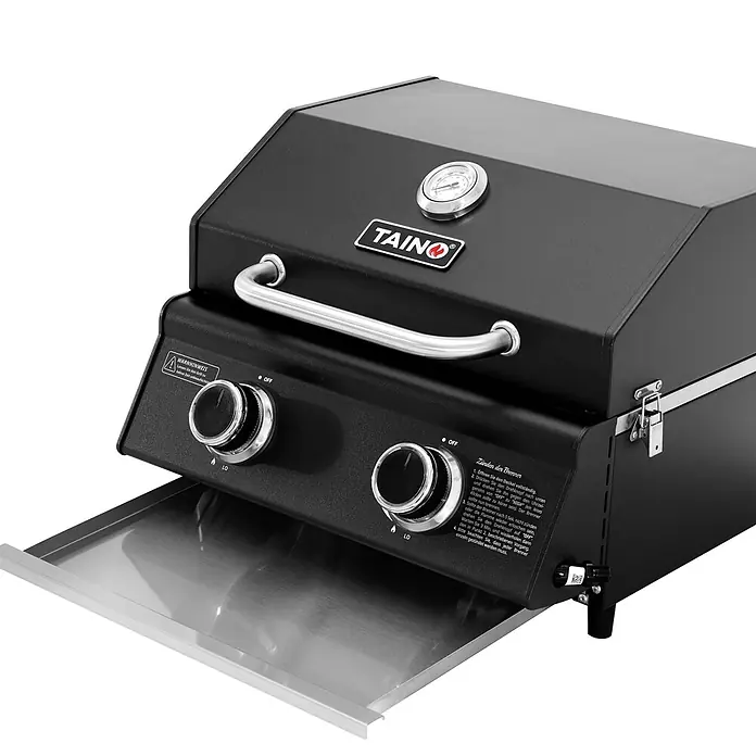 TAINO Gasgrill PLATINUM COMPACT - 2,2 kW, Anzahl Brenner: 2 Stk. - Schwarzer Gasgrill mit silbernen Griffen, zwei Bedienknöpfen, einer Temperaturanzeige und einer ausziehbaren Edelstahlwanne.