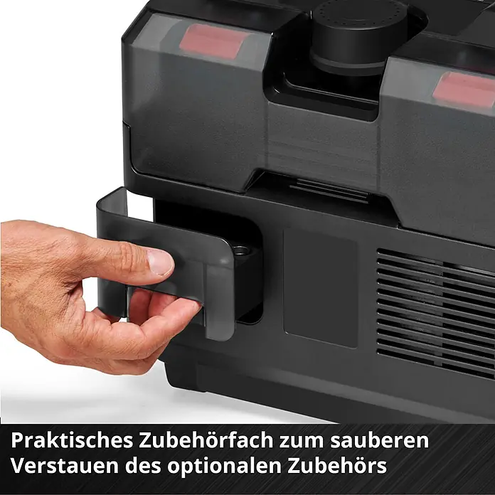 Einhell Power X-Change 18V Akku-Kompressor TE- AC 36/150 Li OF-Solo - 36 V, Ohne Akku, 8 bar - Eine Hand öffnet ein schwarzes Zubehörfach aus Kunststoff an einem Gerät zur Aufbewahrung von optionalem Zubehör.