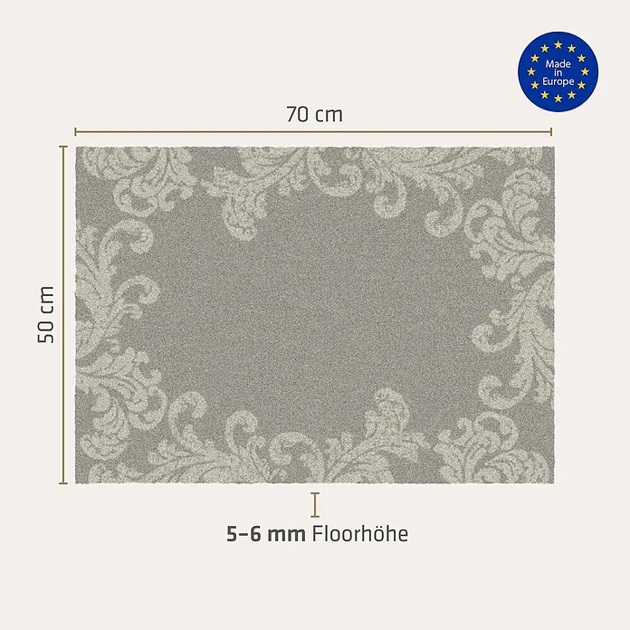 Akzente Fußmatte Feel - Mehrfarbig, Motiv / Muster|Floral - Grauer rechteckiger Teppich mit hellem, verziertem Rand, 70x50 cm, 5-6 mm Florhöhe.
