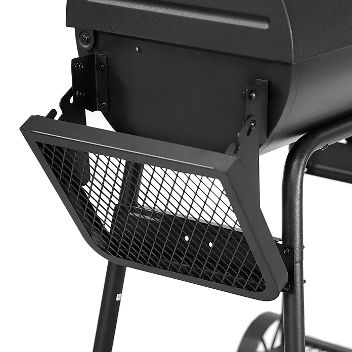 TAINO Smoker KAMAYO - Schwarz - Schwarze Gitter-Seitenablage aus Metall, an einem Grillkörper befestigt.