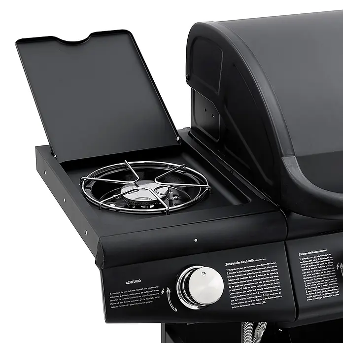 TAINO Gasgrill RED 4+1 - Anzahl Brenner: 4 Stk. - Ein schwarzer Gasgrill-Seitenbrenner mit geöffnetem Deckel, der das Metallrost und einen silbernen Drehknopf zeigt. Deutsche Anweisungen sind sichtbar.