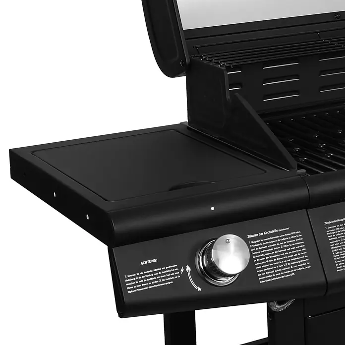TAINO Gasgrill RED 6+1 -  - Nahaufnahme des schwarzen Seitenbrenners eines Gasgrills mit Metallregler und aufgedruckten Anweisungen.