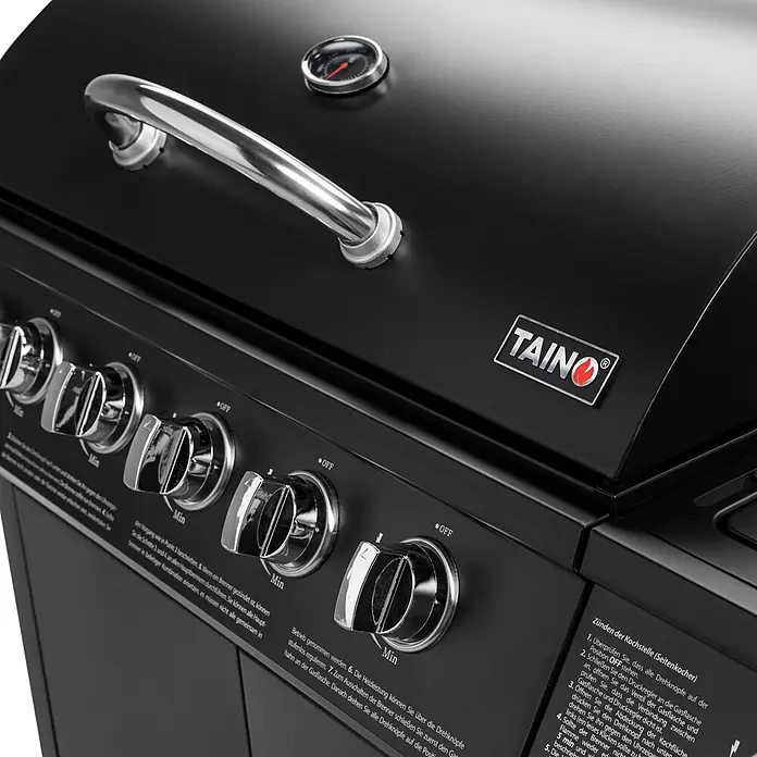 TAINO Gasgrill BASIC 6+1 - Anzahl Brenner: 6 Stk. - Nahaufnahme eines schwarzen Gasgrills mit verchromten Bedienknöpfen und Deckelthermometer. Mit TAINO Markenlogo.