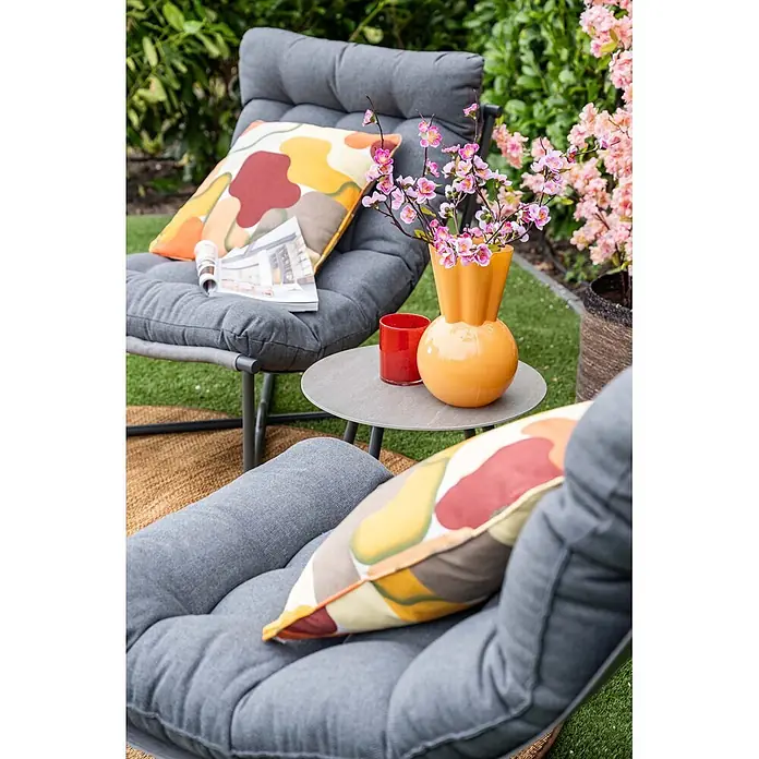 Garden Impressions Loungemöbel-Set Danzig - 3 -tlg., Aluminium, Polyester, Schwarz/Grau - Zwei bequeme graue Gartenstühle mit farbigen Kissen, Beistelltisch und Blumenvase in einer Gartenumgebung.