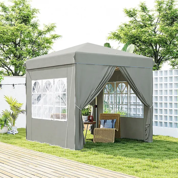 Outsunny Faltpavillon - B x T: 248 x 250 cm, Farbe Dach: Hellgrau - Grauer Gartenzeltpavillon aus Stoff mit weiß gerahmten Fenstern und Sitzbereich im Garten neben Holzdeck.