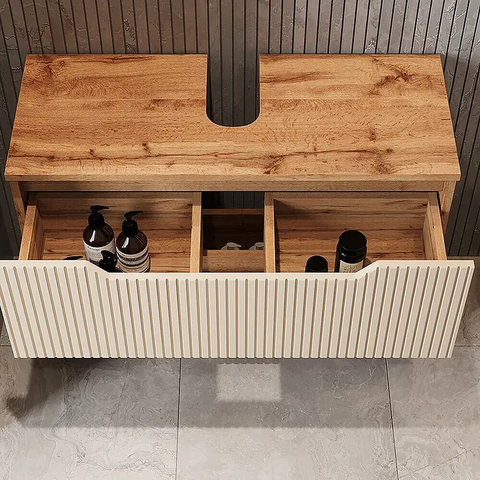 Vicco Badmöbel-Set Lotta Cashmere 3 Teile - Cashmere, Matt - Waschtischunterschrank aus Holz mit offener, gerippter cremefarbener Schublade, die interne Fächer und einen Siphonausschnitt zeigt.