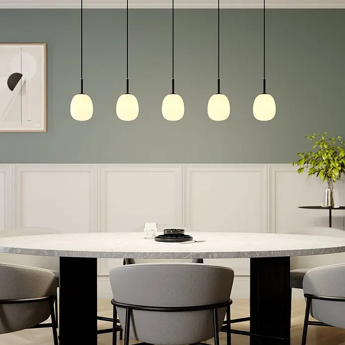 Lindby Pendelleuchte Etiena - L x B x H: 116 x 13 x 15 cm, opalweiß, Schwarz matt, G9 - Fünf moderne Pendelleuchten mit schwarzen Kabeln und matten, weißen, ovalen Schirmen, über einem Esstisch hängend.
