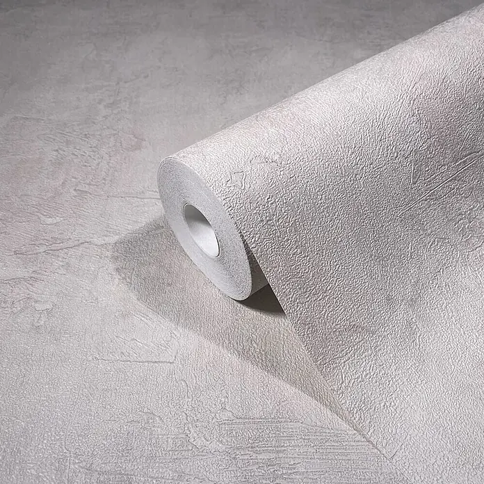 Marburg Loft Superior Vliestapete Struktur I - Creme, Sonstiges, 10,05 x 0,53 m - Ein Rolle hellgrauer, strukturierter Tapete, teilweise abgerollt, zeigt ihre geprägte Oberfläche.