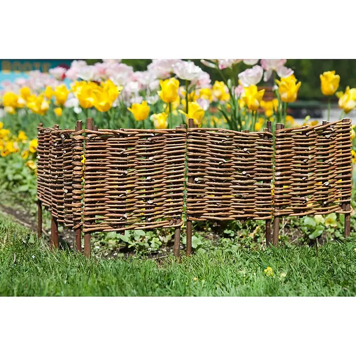 Windhager Beeteinfassung Typ 12 - Weide, 100 x 35 cm - Niedriger brauner Flechtzaun aus Holz, der ein Blumenbeet mit bunten Tulpen begrenzt.