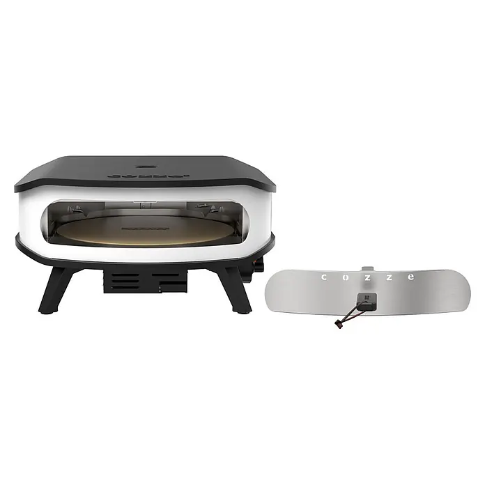 Cozze Pizzaofen mit drehbarem Pizzastein - Durchmesser Grillfläche: 42,5 cm, 6 kW, Weiß/Schwarz, Stahl - Weißer und schwarzer Outdoor-Pizzaofen mit rundem Backstein, dazu ein separates silbernes Thermometer mit dem 'cozze'-Logo.