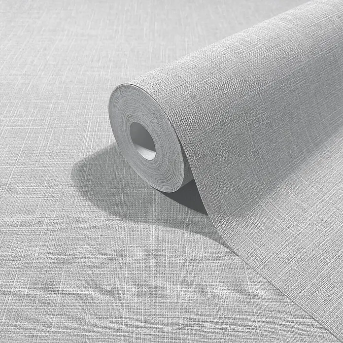 Marburg Boho Vliestapete Uni - Hellgrau, Uni, 10,05 x 0,53 m - Hellgraue Tapetenrolle in Leinenoptik, teilweise abgerollt, um ihre textile Textur zu zeigen.