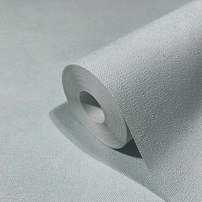 Marburg Shades Iconic Vliestapete Uni - Hellblau, Uni, 10,05 x 0,53 m - Hellblau-graue Tapetenrolle mit körniger Textur, teilweise abgerollt.