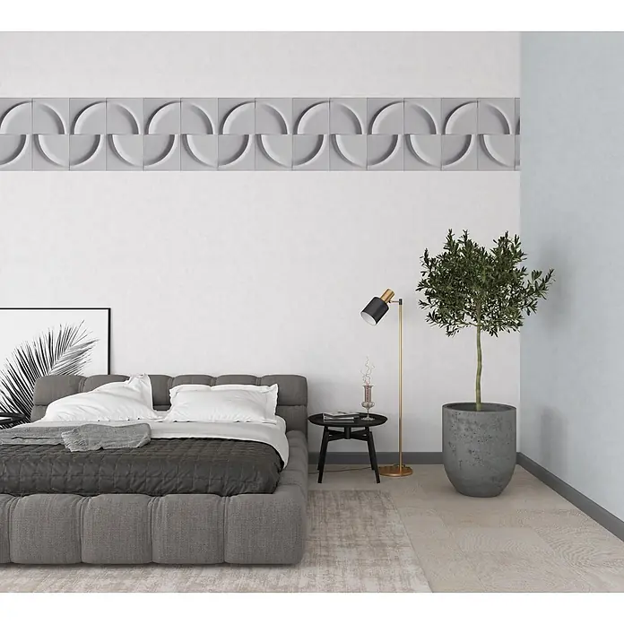 Marburg Shades Iconic Vliestapete Grafik I - Grau, Grafisch, 10,05 x 0,53 m - Graue geometrische 3D-Wandpaneele mit kreisförmigem Muster, über einem Bett in einem modernen Schlafzimmer installiert.