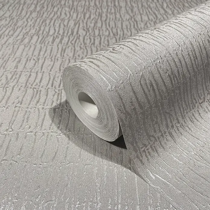 Marburg Kumano Vliestapete Struktur - Steingrau, Sonstiges, 10,05 x 0,53 m - Helle graue strukturierte Tapetenrolle, teilweise abgerollt, mit einem Wellenmuster.