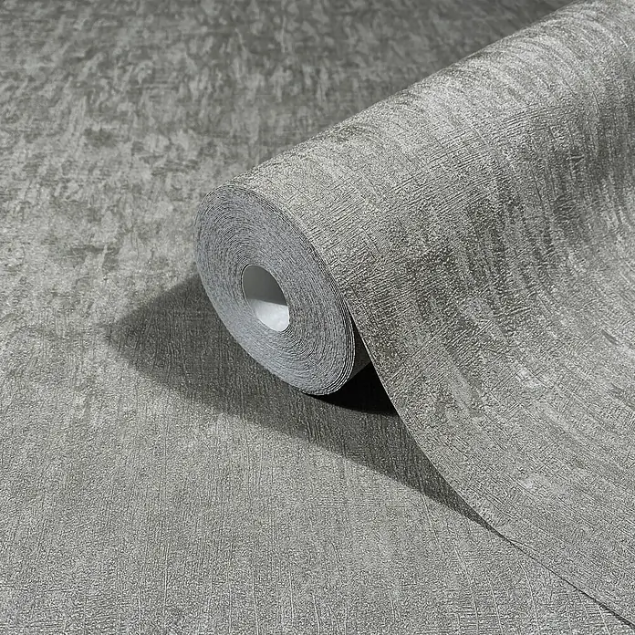 Marburg Ritus Vliestapete Uni - Dunkelgrau, Uni, 10,05 x 0,53 m - Strukturierte graue Tapetenrolle mit abstraktem, gebürstetem Design, teilweise abgerollt.