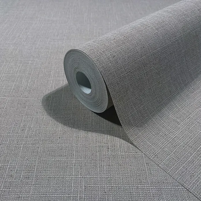 Marburg Boho Vliestapete Uni II - Grau-Braun, Uni, 10,05 x 0,53 m - Graue Tapetenrolle mit Leinenstruktur, teilweise abgerollt, um ihr gewebtes Muster zu zeigen.
