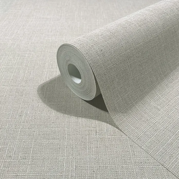 Marburg Boho Vliestapete Uni - Beige-Grau, Uni, 10,05 x 0,53 m - Rolle hellgrauer Tapete mit Leinenstruktur, teilweise abgerollt, um ihr gewebtes Muster zu zeigen.