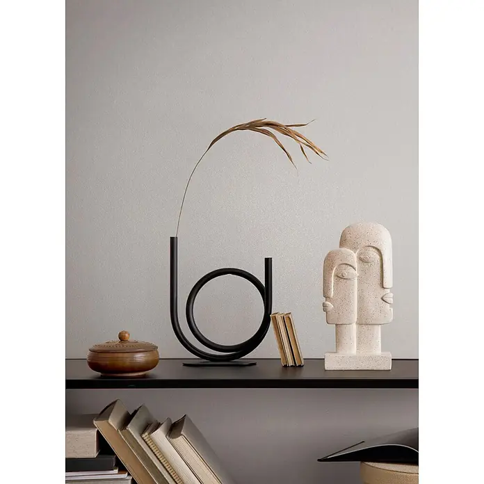 Marburg Vliestapete Novamur Naomi Uni I - Greige, Uni, 10,05 x 0,53 m - Moderne Regaldekoration mit schwarzer Vase, Trockenblättern und beiger Gesichterskulptur.