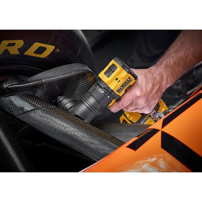 DeWalt XR 18V Taladro atornillador de batería DCD803D2T - 18 V, 2 baterías, 2 Ah, 73 Nm - Taladro-atornillador DeWalt 18V XR amarillo y negro, sujetado por una mano, usado en un componente de fibra de carbono.