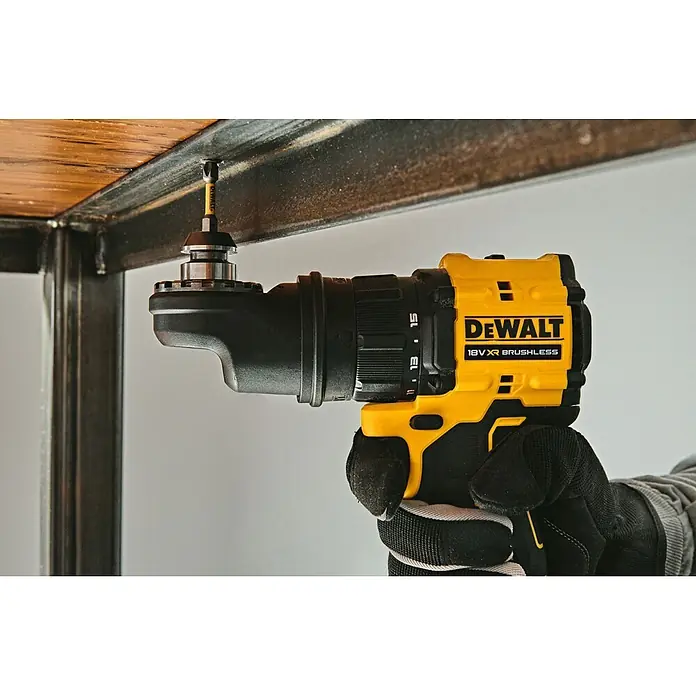 DeWalt XR 18V Taladro atornillador de batería DCD803D2T - 18 V, 2 baterías, 2 Ah, 73 Nm - Una mano enguantada sostiene un taladro DeWalt amarillo y negro con un accesorio angular, atornillando en madera bajo un marco metálico.