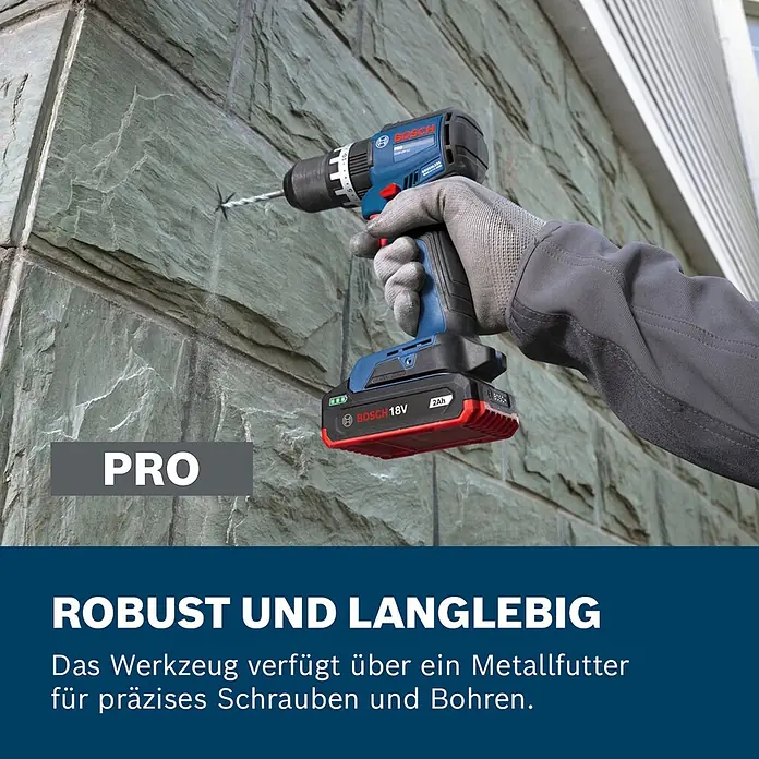 Bosch Professional AMPShare 18V Akku-Schlagbohrschrauber - 18 V, Ohne Akku, 70 Nm, Ohne L-BOXX 136 - Ein blauer und schwarzer Bosch Akkuschrauber mit rotem 18V 2Ah Akku bohrt in eine Steinwand. Er verfügt über ein Metallfutter für präzises Arbeiten.
