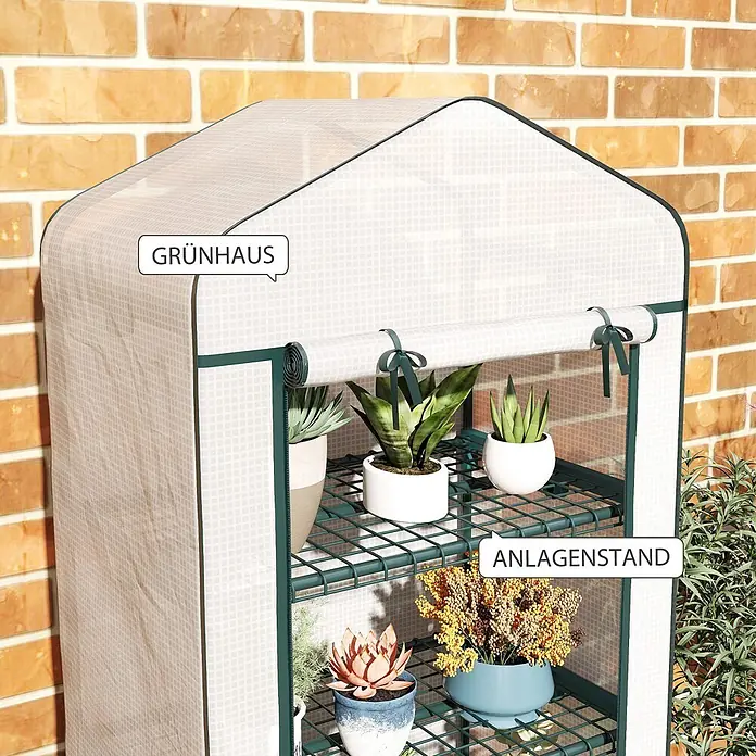 Furnicato Gewächshaus - 50 x 69 cm, Material Seitenwand: Stahl, 14 mm, weiß - Kleines, tragbares Gewächshaus mit durchscheinender Abdeckung und dunkelgrünem Gestell, mit Topfpflanzen vor einer Ziegelwand.