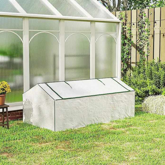 Outsunny Gewächshaus - Außenmaß inkl. Dachüberstand (B x T): 180 x 90 cm, Material Seitenwand: Kunststoff, 0,3 mm, Grün - Weißes, durchscheinendes Mini-Gewächshaus mit grünem Rand auf Rasen vor einem großen Gewächshaus.