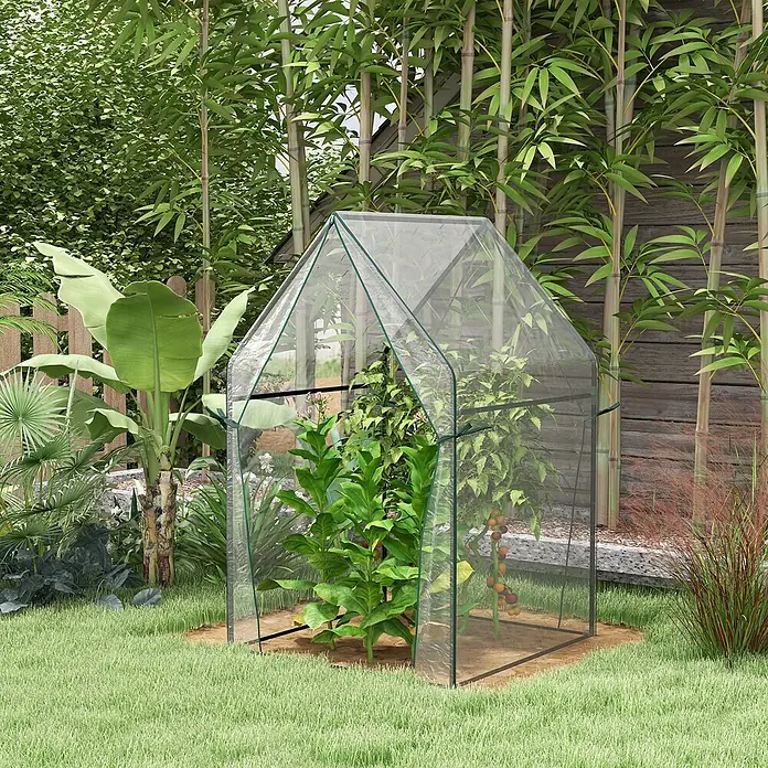 Furnicato Gewächshaus - 90 x 145 cm, Material Seitenwand: Stahl, 14 mm, silber - Kleines, klares Kunststoffgewächshaus mit grünem Rahmen, beherbergt Pflanzen in einem Garten.