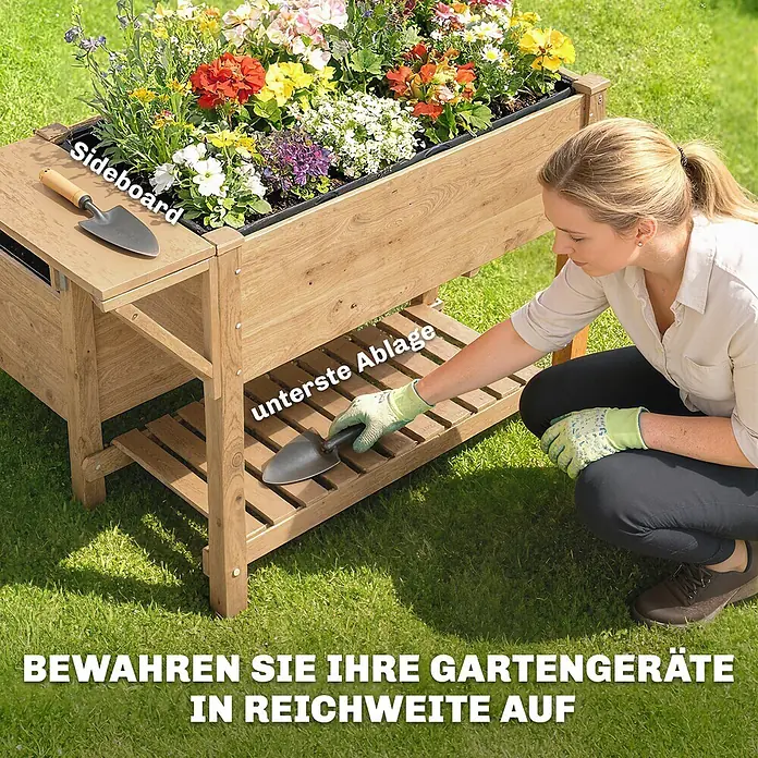 Outsunny Hochbeet - 119,5 x 102 x 76,5 cm, Holz, Naturholz - Holz-Hochbeet mit bunten Blumen, mit einem Seitenregal und einer unteren Ablage. Eine Person legt eine Schaufel auf die untere Ablage.