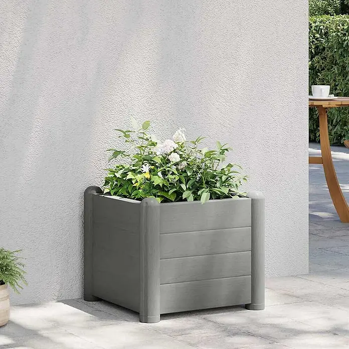 Furnicato Hochbeet - 43 x 43 x 35 cm, Kunststoff, Grau - Grauer quadratischer Pflanzkübel mit vertikalen Pfosten, gefüllt mit Grünpflanzen und weißen Blumen, auf einer Terrasse.
