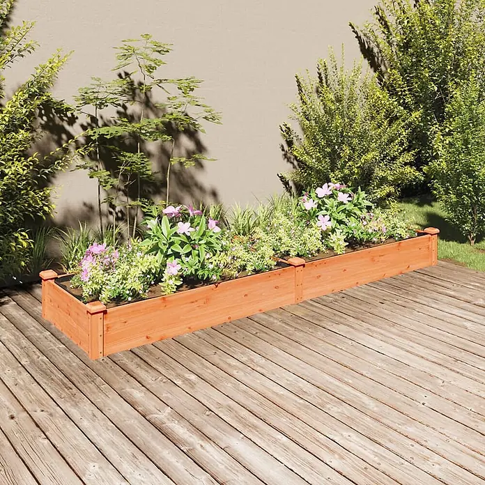 Furnicato Hochbeet - 60 x 240 x 25 cm, Holz, Braun - Langes Hochbeet aus Naturholz, gefüllt mit grünen Pflanzen und rosa Blumen, auf einer Holzterrasse.
