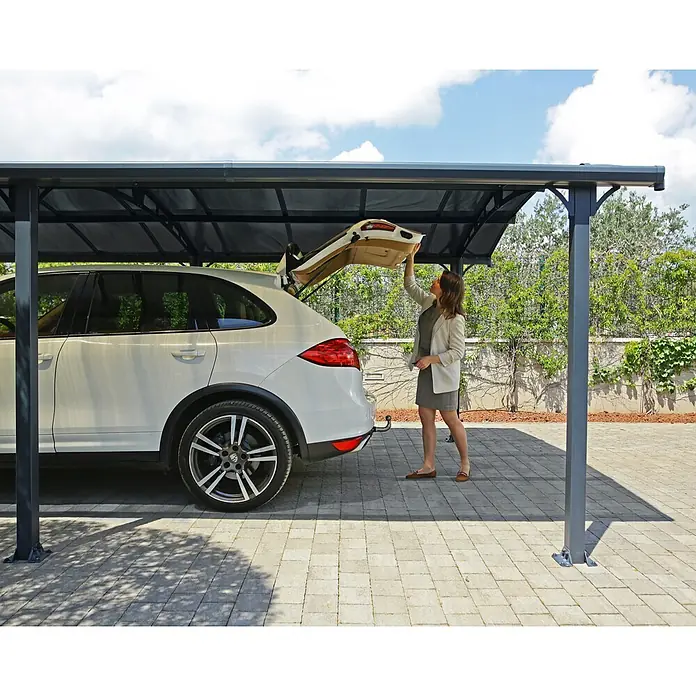Palram – Canopia Carport Arcadia - Medidas ext. (An x Pr): 3,59 x 12,9 m, Carport doble, Gris - Cochera gris oscuro protegiendo un SUV blanco, demostrando su función.