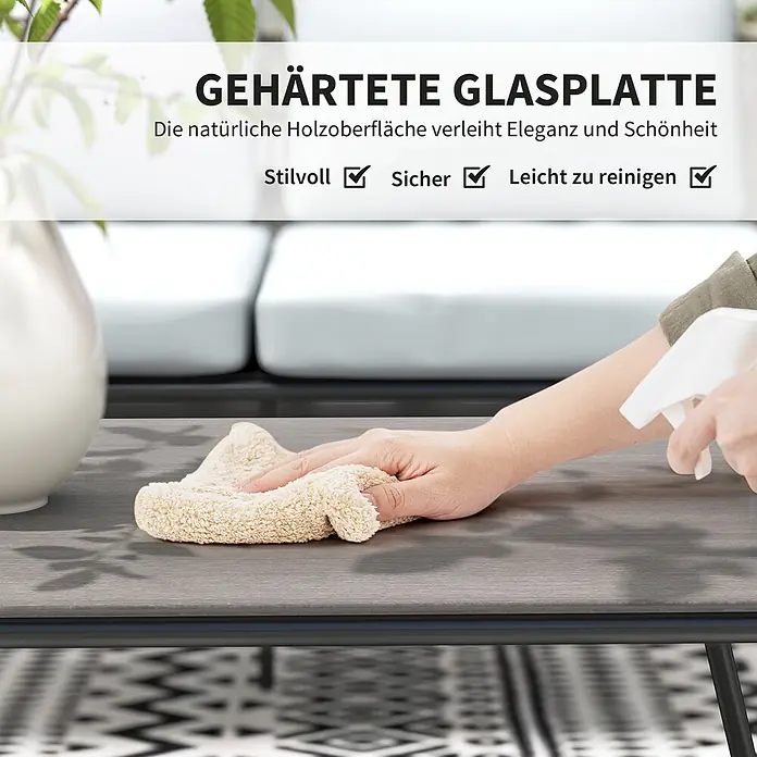 Outsunny Gartenstuhl-Set Lounge-Set mit Sofa - 4 Stk., PE-Rattan, Stahl, gehärtetes Glas, Polyester, Schaumstoff, Grau - Eine Hand reinigt eine grau-holzstrukturierte Tischplatte aus gehärtetem Glas mit einem Tuch.