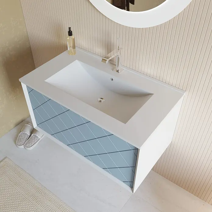 Kiamami Valentina Badmöbel-Set - Hellblau - Moderner weißer Badunterschrank mit integriertem Waschbecken und hellblauen Schranktüren mit Rautenmuster.