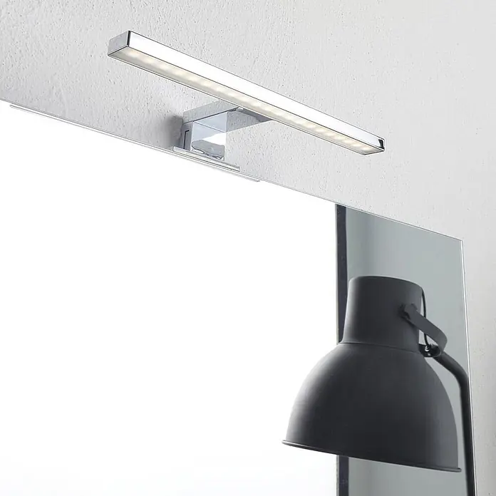 Kiamami Valentina Badmöbel-Set - Beige - Verchromte LED-Spiegelleuchte über einem Spiegel montiert.