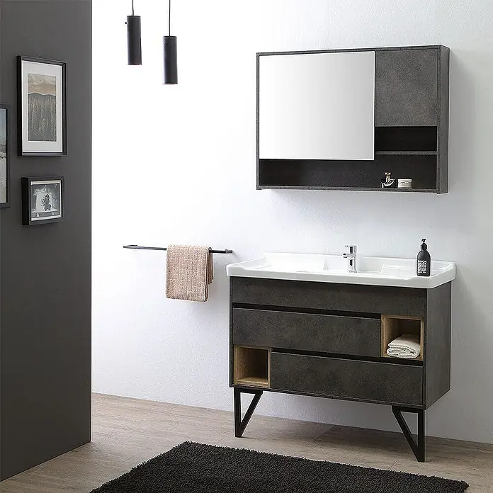 Kiamami Valentina Badmöbel-Set - Grau - Dunkelgrauer Badunterschrank mit weißem Waschbecken, schwarzen Beinen und passendem Spiegelschrank mit offenen Fächern.