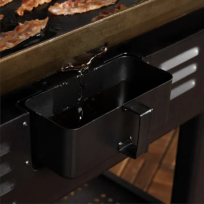 Blackstone Plancha-Grill 36" Omnivore - Grillfläche (B x T): 91 x 55 cm, 11,2 kW, Anzahl Brenner: 4 Stk. - Schwarze Metall-Fettschale fängt Tropfen von Speck auf einem Grillrost auf.