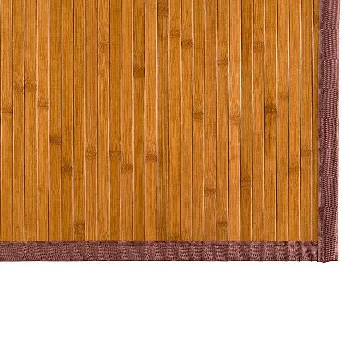 Alfombra de bambú - Miel, 120 x 180 cm - Vista detallada de una estera de bambú con borde marrón, mostrando su textura natural y cálida paleta de colores, ideal para suelos.