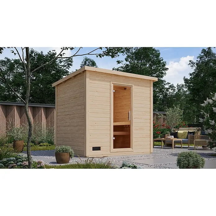 Karibu Saunahaus Kaapi 4 - Ohne Ofen, Natur, L x B x H: 196 x 231 x 238 cm - Helle Holz-Außensauna mit Glastür in einem grünen Garten.