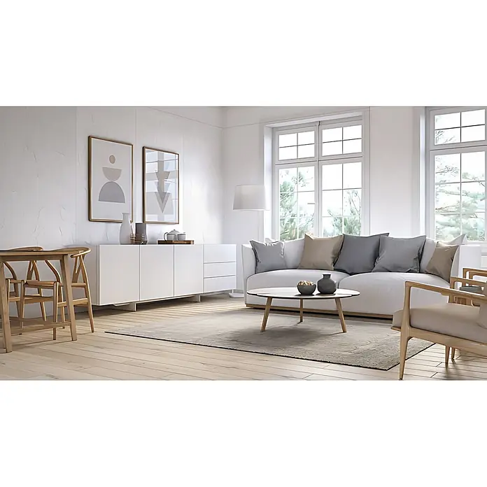 Wallface Wandpaneel 24943 CREPA Snow White Wandverkleidung 3D matt weiß 2,6 m2 - 2.600 x 1.000 mm - Ein helles, modernes Wohnzimmer mit weißem Sofa, Holztisch, Sessel und weißem Sideboard. Ein heller Teppich liegt auf Holzboden.