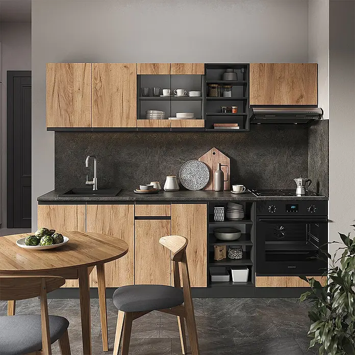Vicco Küchenzeile R-Line Goldkraft Eiche/Anthrazit J-Shape, AP Eiche - Goldkraft Eiche, Ohne Elektrogeräte - Moderne Küche mit Holzoptik-Schränken, dunklen Arbeitsplatten, Spüle, Backofen und Kochfeld. Ein runder Esstisch mit Stühlen steht im Vordergrund.