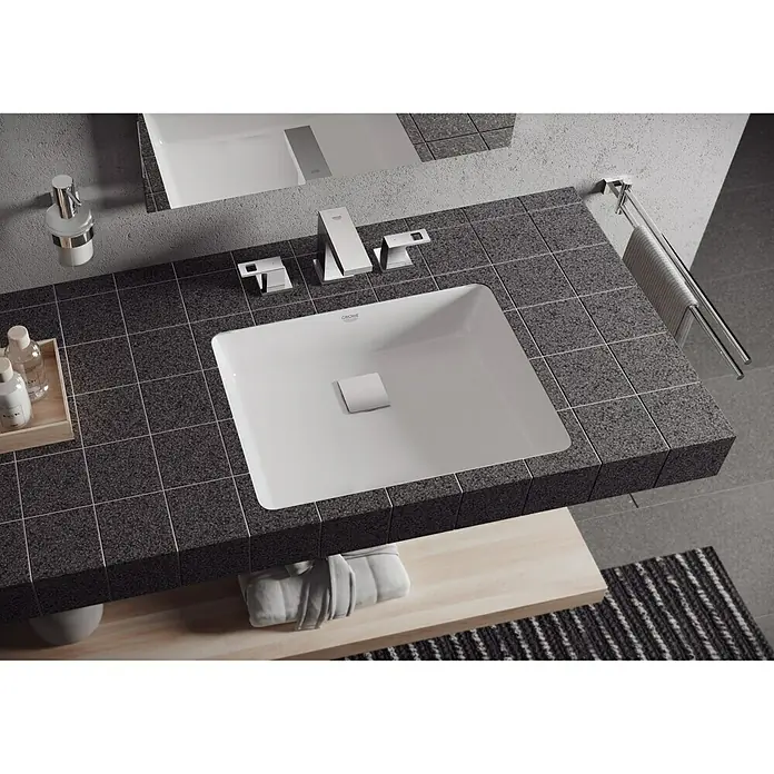 Grohe Essentials Cube Handtuchhalter - 2-armig, Chrom, Glänzend - Ansicht von oben auf ein modernes Badezimmerwaschbecken mit Armaturen und Handtuchhalter, das elegante Designelemente zeigt.