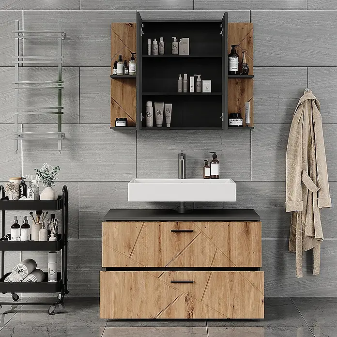Vicco Badmöbel-Set Irma Anthrazit/Artisan 2 Teile - Anthrazit, Matt - Modernes Badezimmer mit einem Waschtisch und Wandschrank in Holzoptik mit geometrischen Mustern, einem weißen Waschbecken und einem schwarzen Rollwagen.