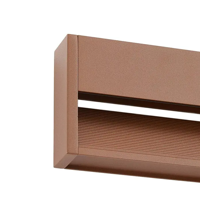 Lucande Außenwandleuchte Trevin - 60 x 60 x 12,8 cm, braun / rost, IP65 - Nahaufnahme eines strukturierten bronzefarbenen Profils mit horizontalem Schlitz und gerippter Platte für ein Rollladen- oder Jalousiesystem.