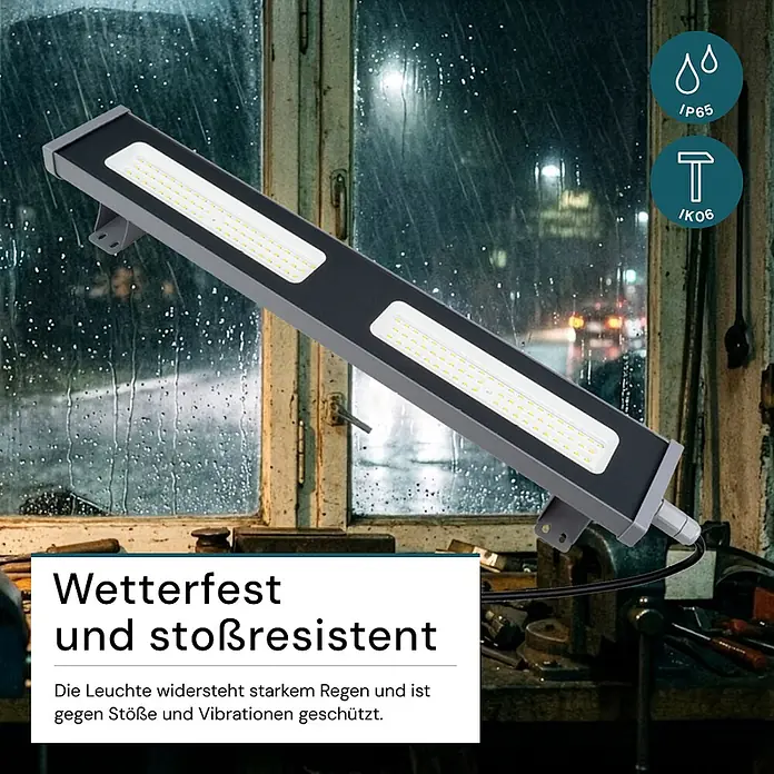 Luxula LED-Strahler LED-Hallenstrahler - 100 W, 12.400 lm, 5.000 K, IP65 - Dunkelgraue LED-Leuchte, wetter- und stoßfest, in regnerischer Umgebung dargestellt.